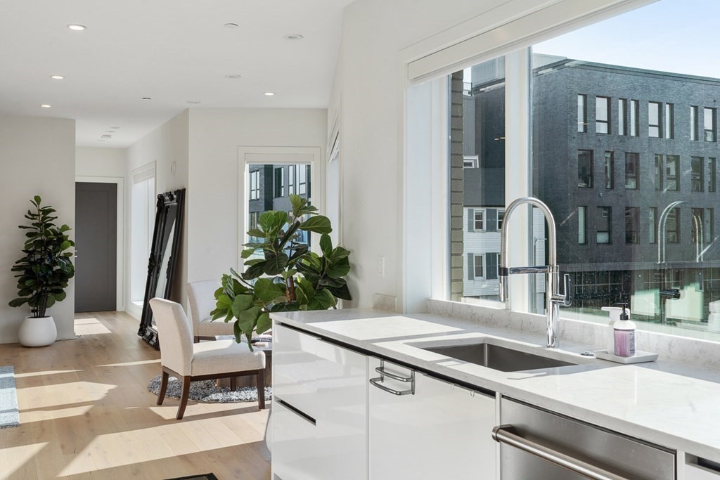 100 A Street, Unit 6 Boston, MA 02127 - Photo 9 of 37 a kitchen with a sink and a refrigerator