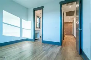 an empty room with wooden floor and a window