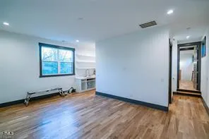 a view of a room with wooden floor and windows