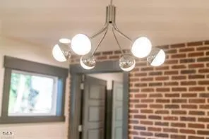 a view of a hallway with windows and chandelier