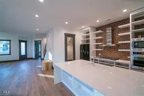 a view of kitchen with refrigerator and window