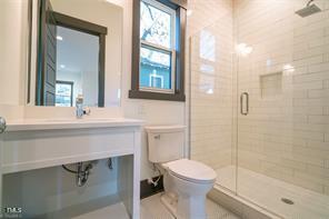 1100 Hazel Street Durham, NC 27701 - Photo 8 of 23 a bathroom with a sink a toilet and shower