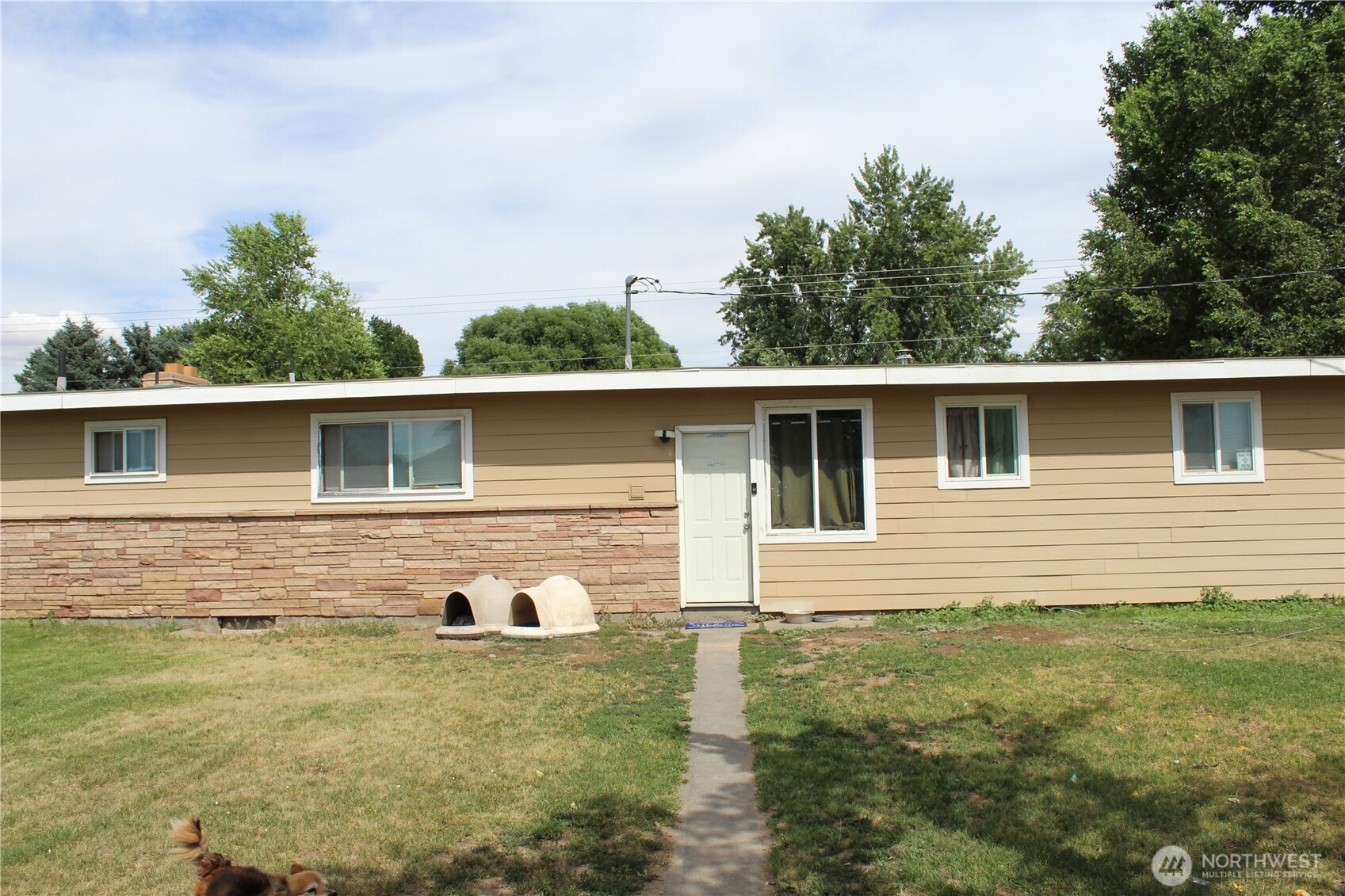 a front view of a house with garden