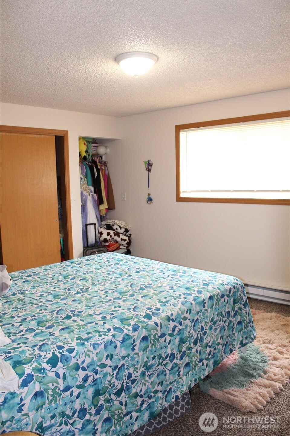 5788 Rd K Northeast Moses Lake, WA 98837 - Photo 37 of 40 a bedroom with a bed and a dresser with wooden floor
