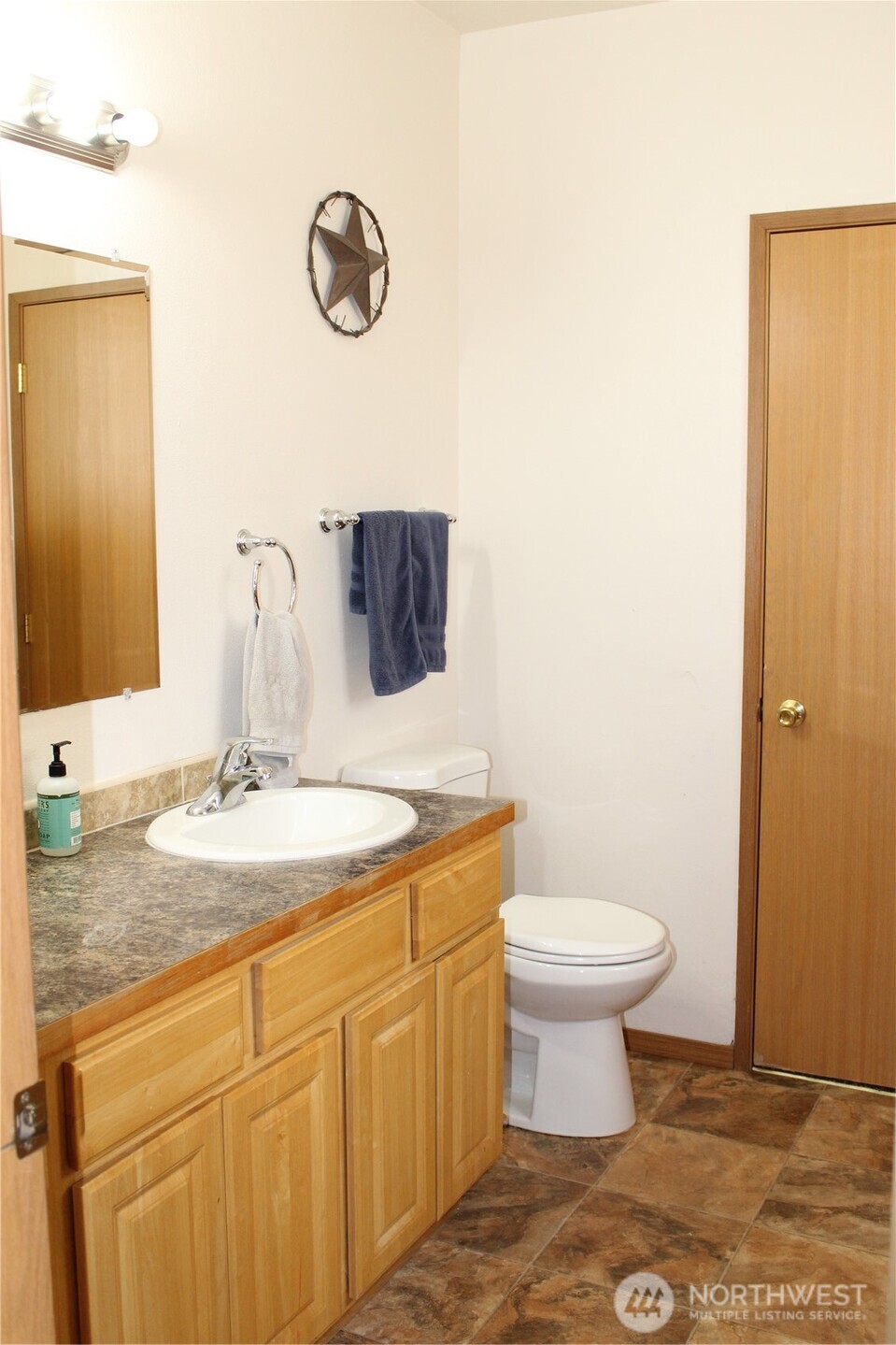 5788 Rd K Northeast Moses Lake, WA 98837 - Photo 40 of 40 a bathroom with a granite countertop toilet sink and mirror