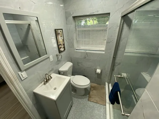 a bathroom with a toilet sink and mirror