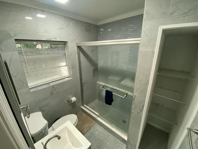 a bathroom with a toilet and a shower
