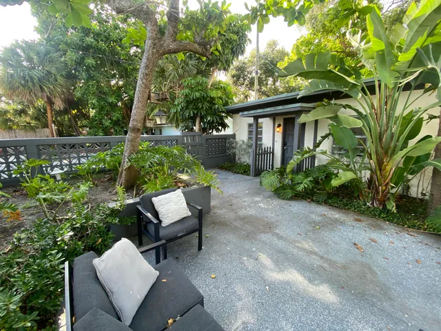 a view of a house with backyard sitting area and garden