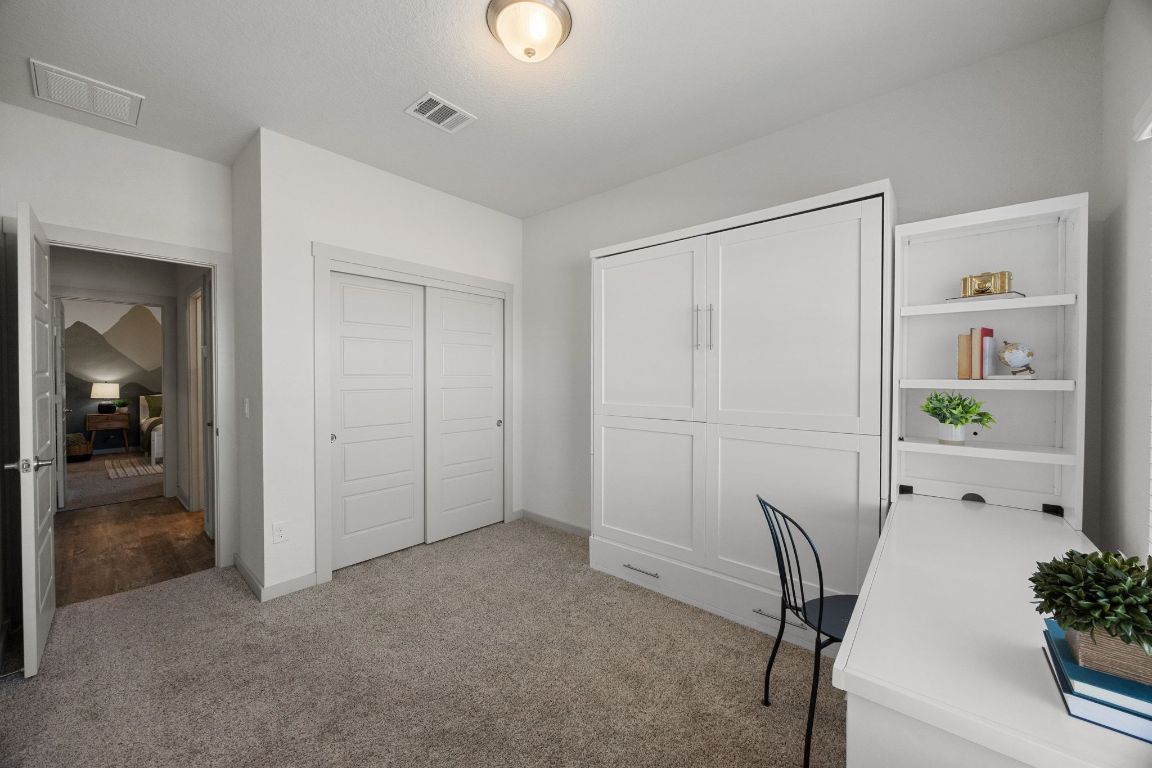 100 Deserti Road Leander, TX 78641 - Photo 21 of 27 Bedroom #3/Office featuring a Murphy bed and built-in desk. Both will convey with the sale.