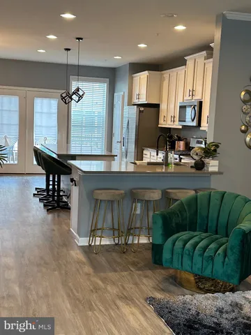 a kitchen with stainless steel appliances kitchen island granite countertop a sink and cabinets