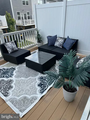 a view of a couches chair and potted plant