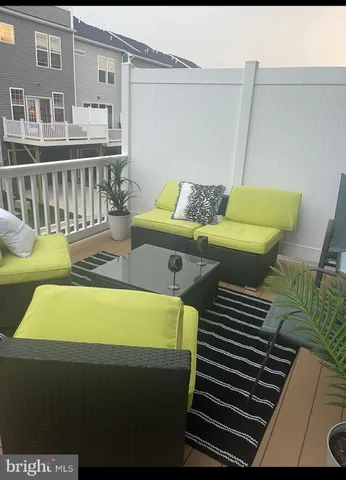 a view of roof deck with furniture