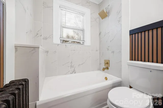 a bathroom with a toilet and a bathtub