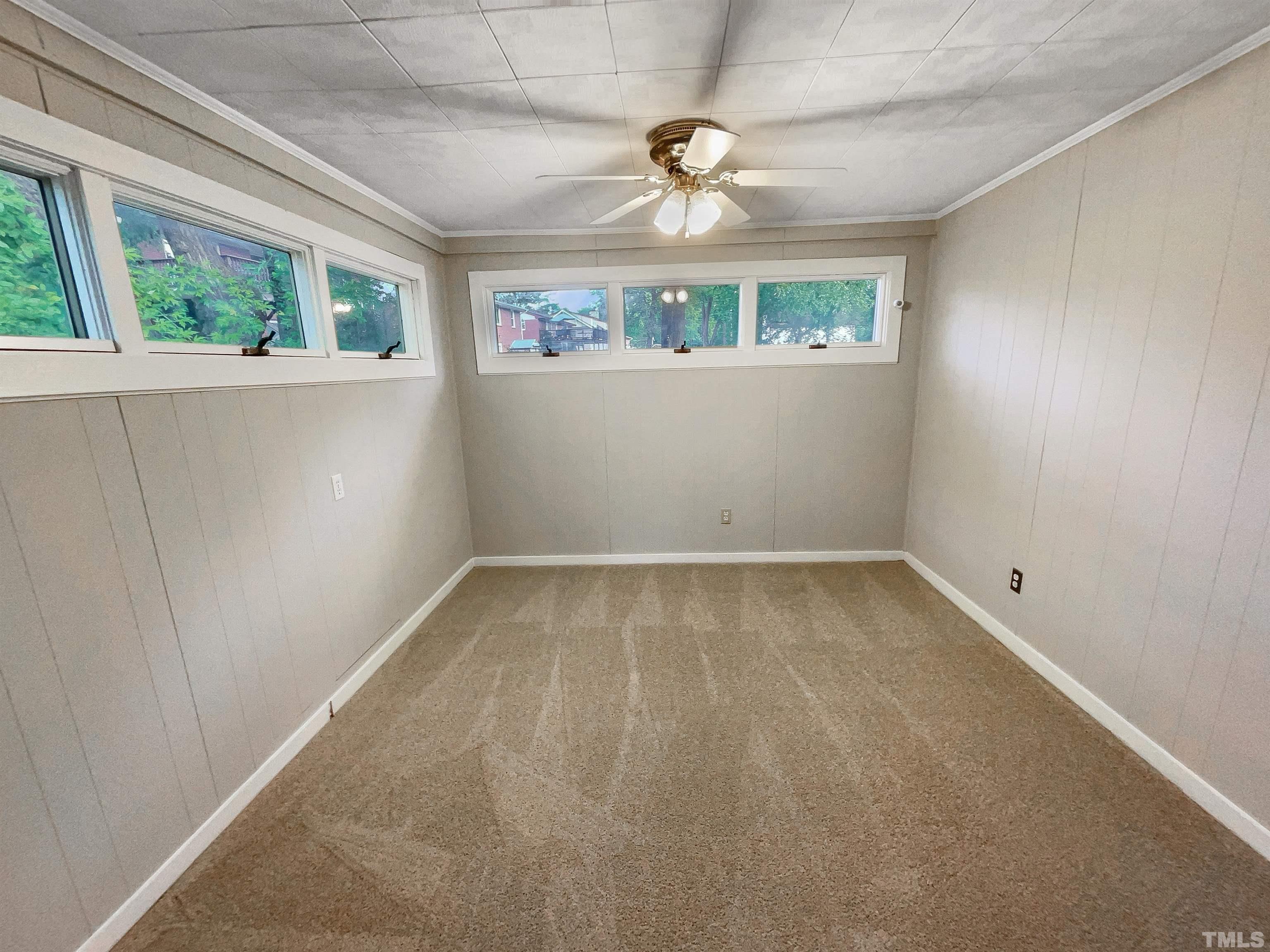 2905 Bardwell Road Raleigh, NC 27604 - Photo 12 of 17 an empty room with windows and chandelier