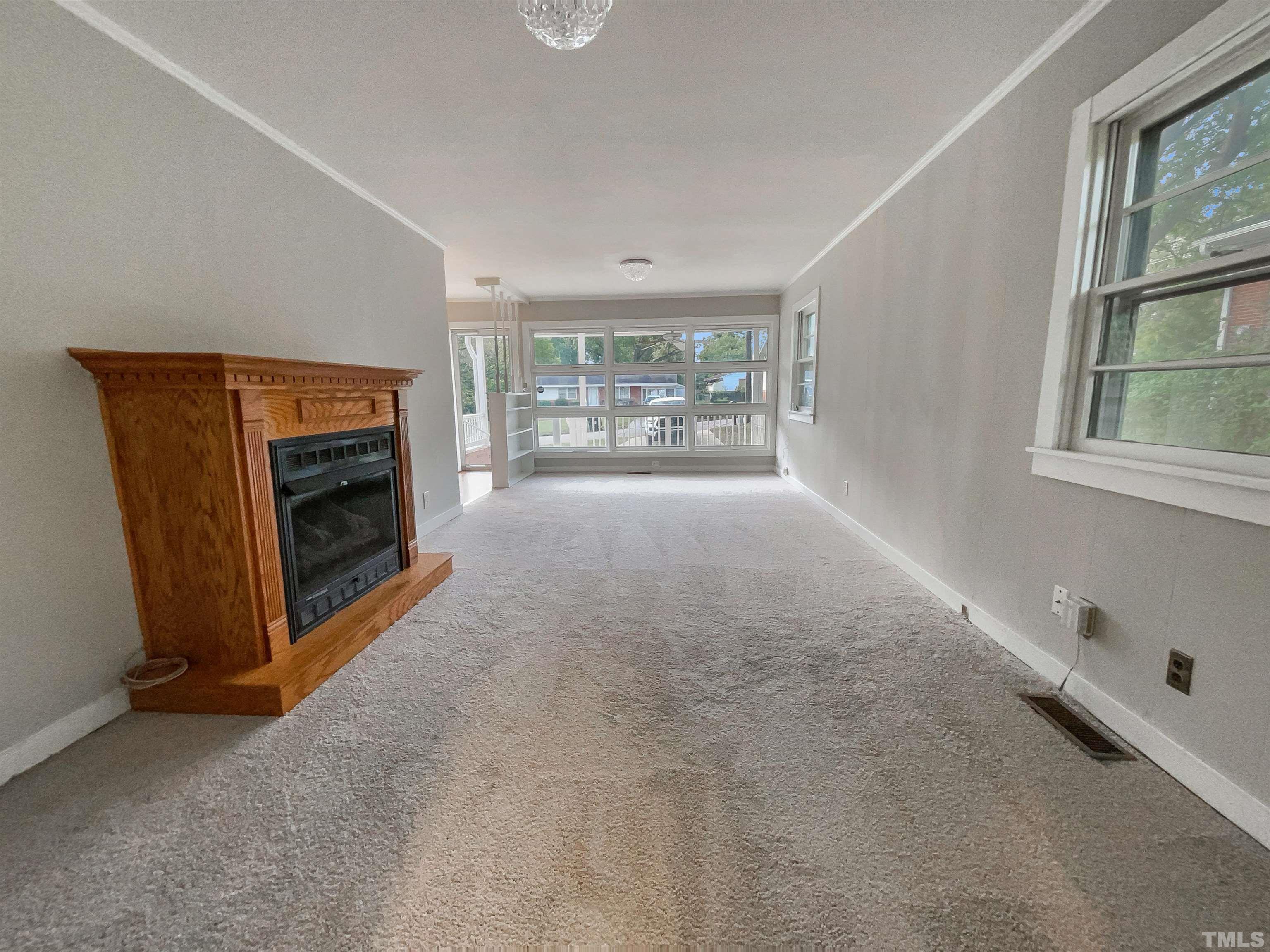 2905 Bardwell Road Raleigh, NC 27604 - Photo 13 of 17 an empty room with windows and fireplace