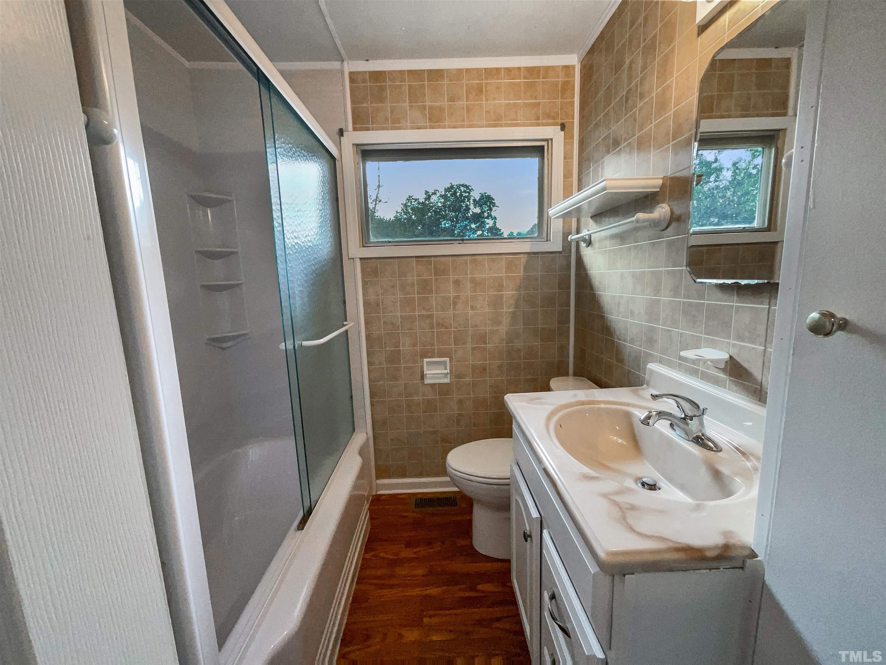 2905 Bardwell Road Raleigh, NC 27604 - Photo 6 of 17 a bathroom with a sink a toilet and shower