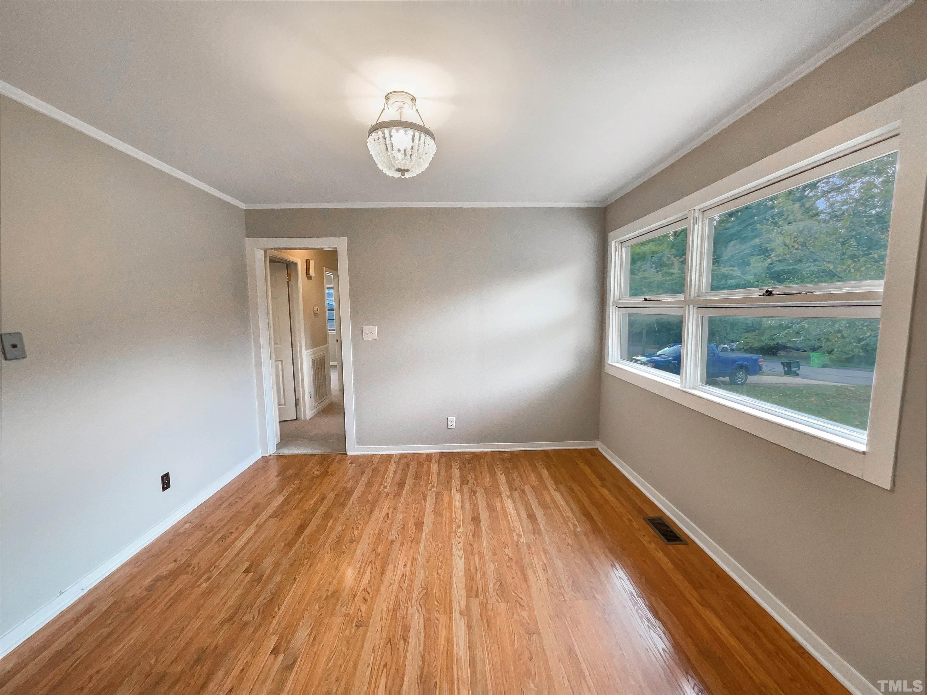 2905 Bardwell Road Raleigh, NC 27604 - Photo 8 of 17 a view of empty room with wooden floor and fan