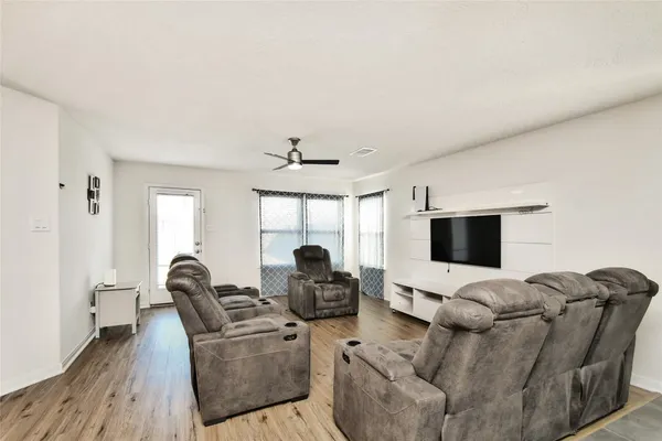 a kitchen with stainless steel appliances kitchen island granite countertop a table chairs and a refrigerator