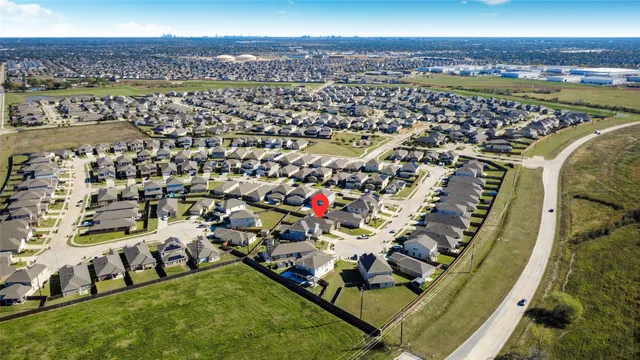 a view of a white house with a big yard and large trees