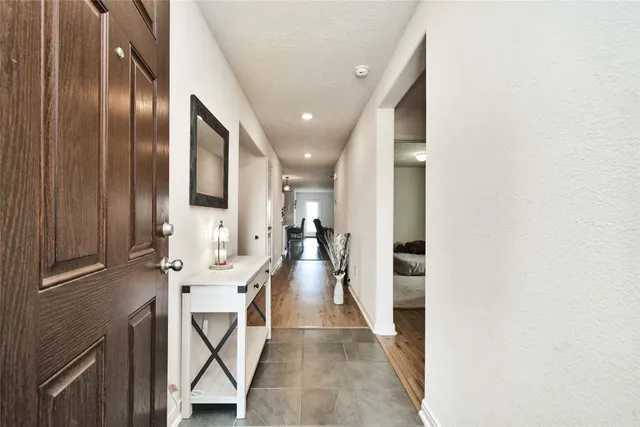 a bedroom with a bed and a mirror on dresser