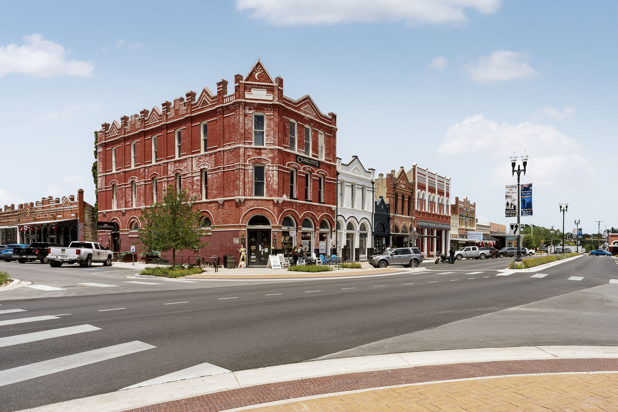 400 Hackberry Street Lockhart, TX 78644 - Photo 38 of 40 A vibrant downtown streetscape showcases charming historic brick and stone architecture with a mix of retail storefronts.