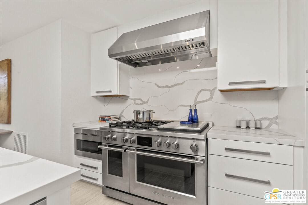 6 Trojan Court Rancho Mirage, CA 92270 - Photo 22 of 51 a kitchen with stainless steel appliances granite countertop a sink and a stove
