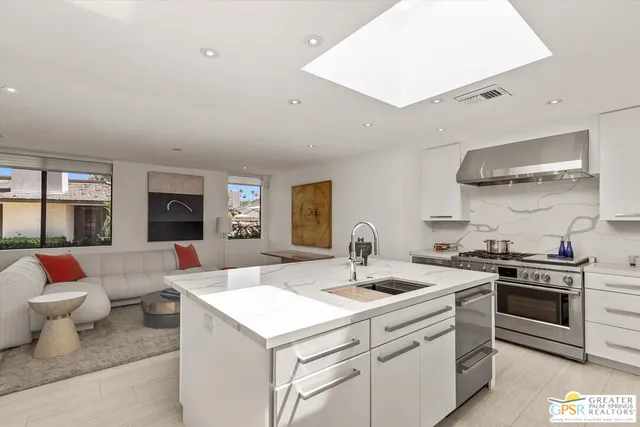 a kitchen with a sink stove and cabinets