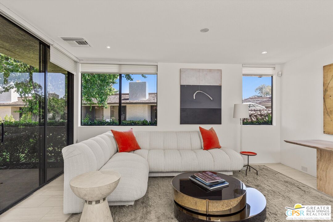 6 Trojan Court Rancho Mirage, CA 92270 - Photo 24 of 51 a living room with a couch and a floor to ceiling window