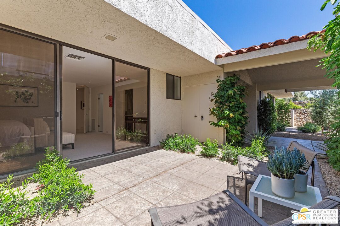 6 Trojan Court Rancho Mirage, CA 92270 - Photo 30 of 51 a patio with table and chairs and potted plants