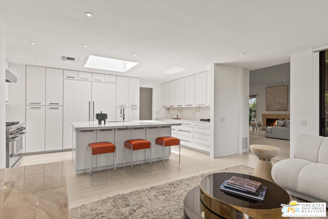 6 Trojan Court Rancho Mirage, CA 92270 - Photo 3 of 51 a living room with furniture a rug and kitchen view