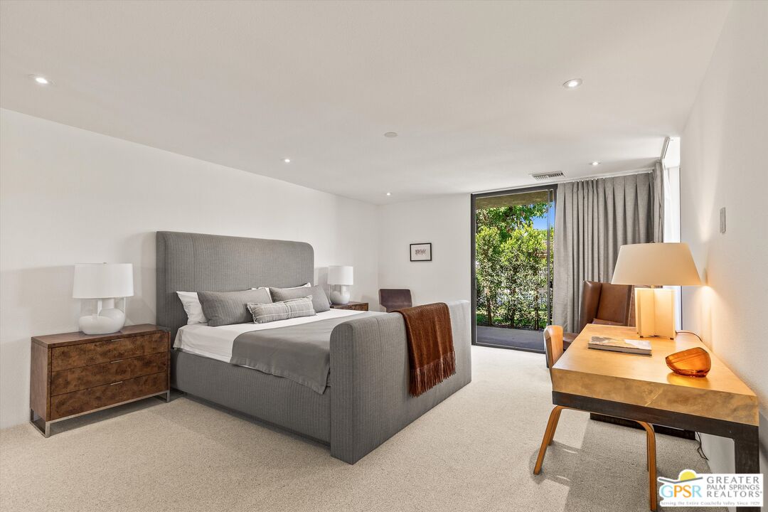 6 Trojan Court Rancho Mirage, CA 92270 - Photo 31 of 51 a bedroom with a bed and lamp