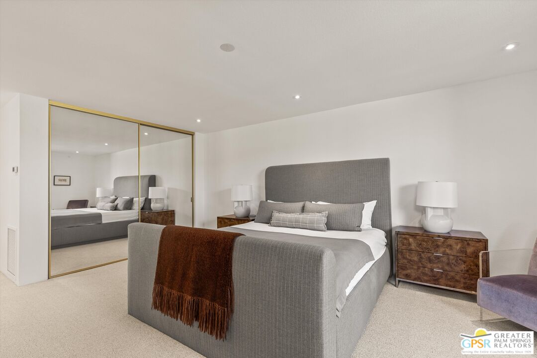 6 Trojan Court Rancho Mirage, CA 92270 - Photo 32 of 51 a large bedroom with a bed and lamp