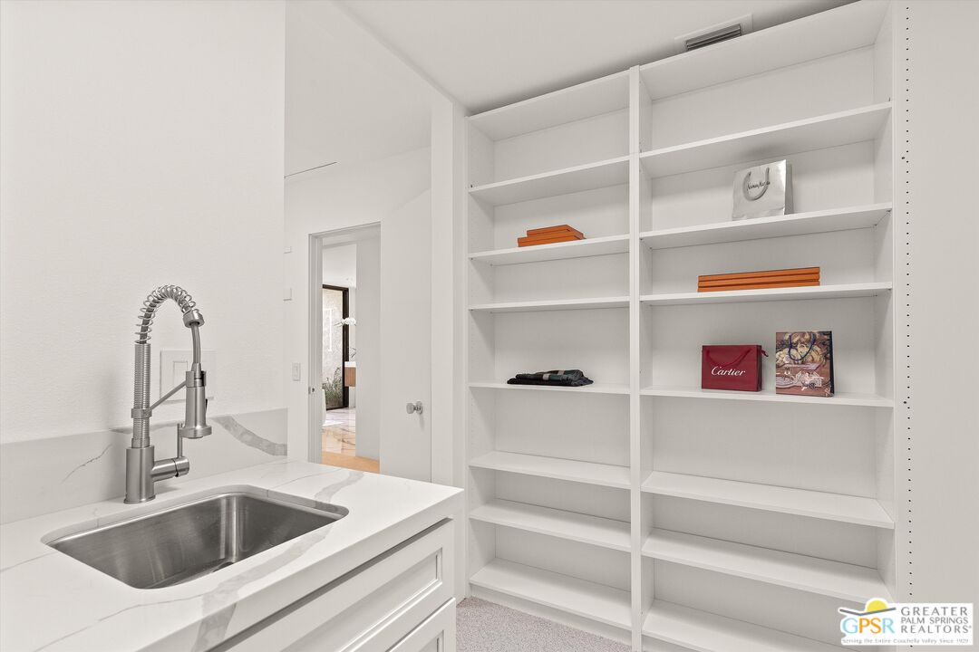 6 Trojan Court Rancho Mirage, CA 92270 - Photo 38 of 51 a kitchen with a sink and a refrigerator