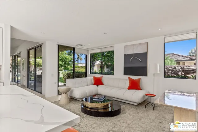 a living room with furniture and a potted plant