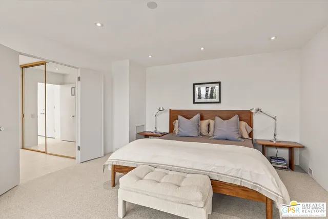 a bedroom with a bed and a lamp