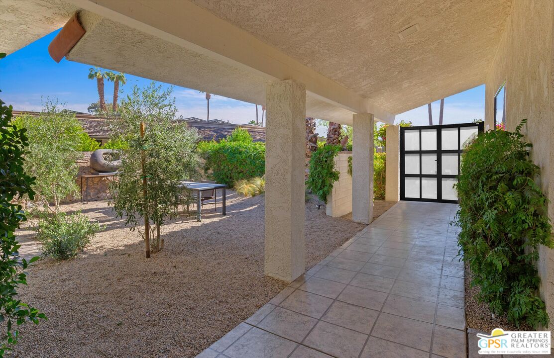6 Trojan Court Rancho Mirage, CA 92270 - Photo 49 of 51 a view of a porch with chairs and potted plants