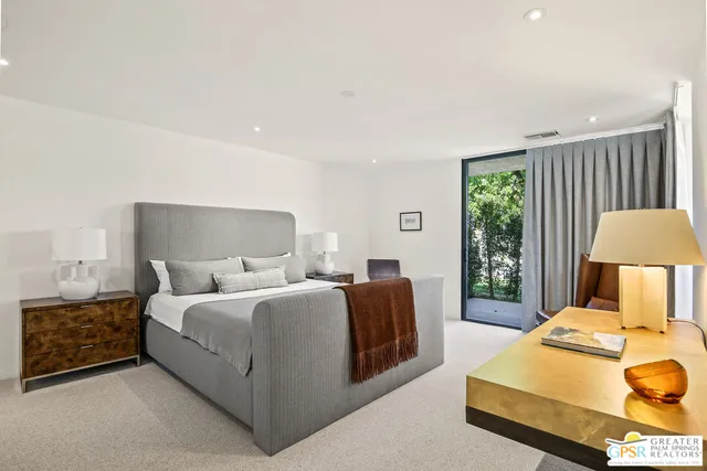 a bedroom with a bed and a lamp