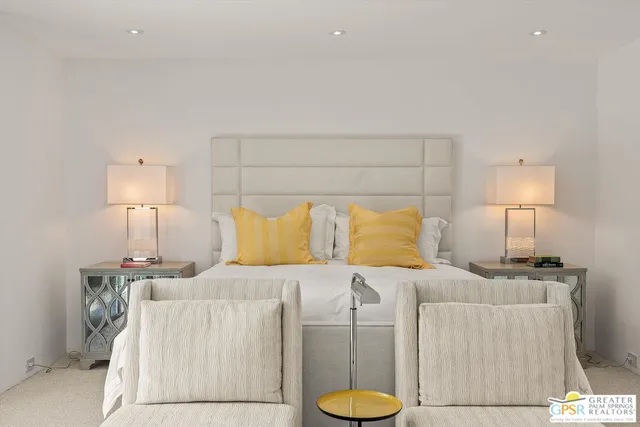 a bedroom with a bed and a lamp