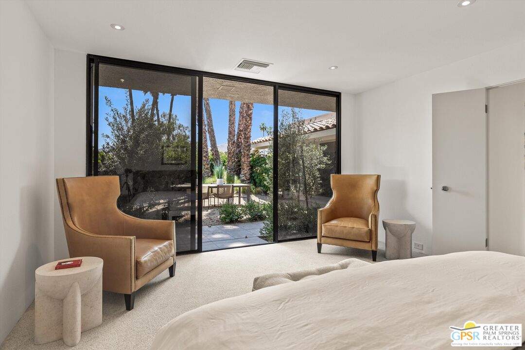 6 Trojan Court Rancho Mirage, CA 92270 - Photo 8 of 51 a bedroom with a bed and a large window