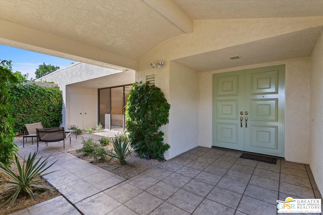 6 Trojan Court Rancho Mirage, CA 92270 - Photo 9 of 51 a view of a entryway door with potted plants in front of house
