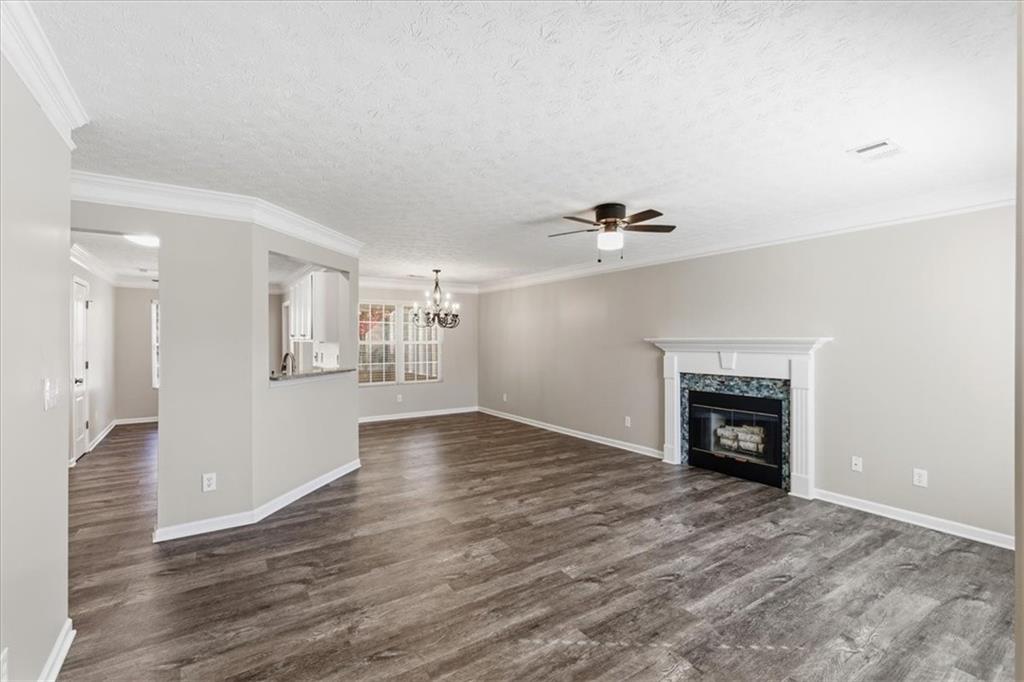 125 Governor Lane Temple, GA 30179 - Photo 11 of 57 a view of an empty room with wooden floor and a fireplace