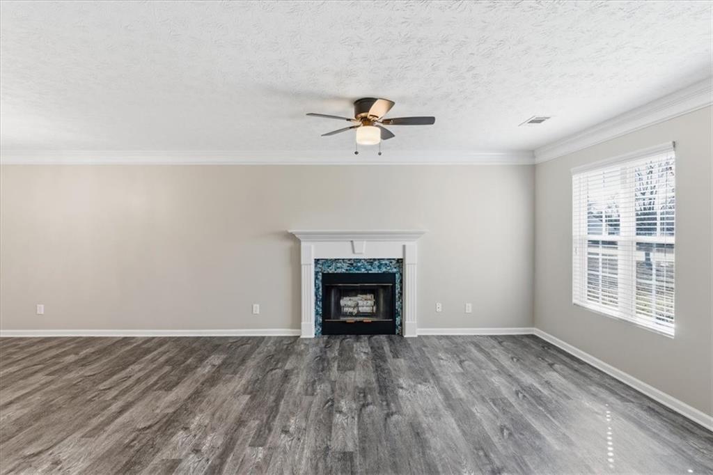 125 Governor Lane Temple, GA 30179 - Photo 12 of 57 wooden floor fireplace and windows in an empty room