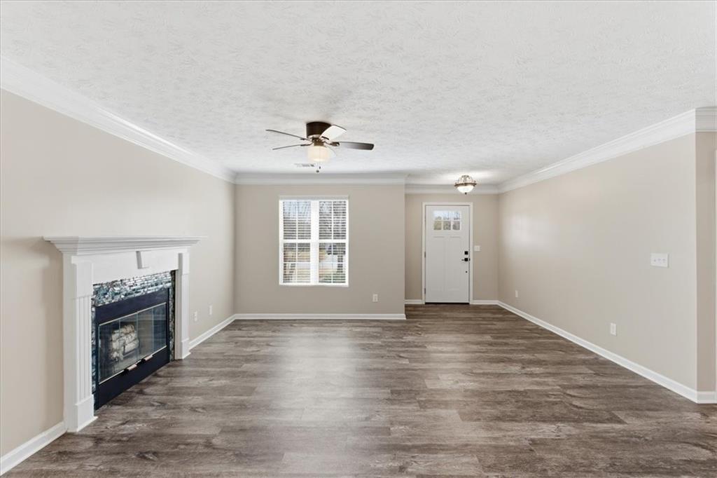 125 Governor Lane Temple, GA 30179 - Photo 15 of 57 a view of an empty room with a window and wooden floor