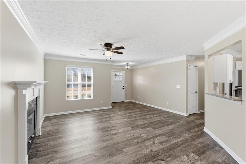 125 Governor Lane Temple, GA 30179 - Photo 16 of 57 a view of an empty room with a window and wooden floor