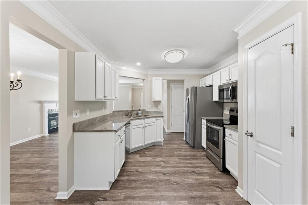 125 Governor Lane Temple, GA 30179 - Photo 18 of 57 a kitchen with stainless steel appliances granite countertop a refrigerator and a stove top oven