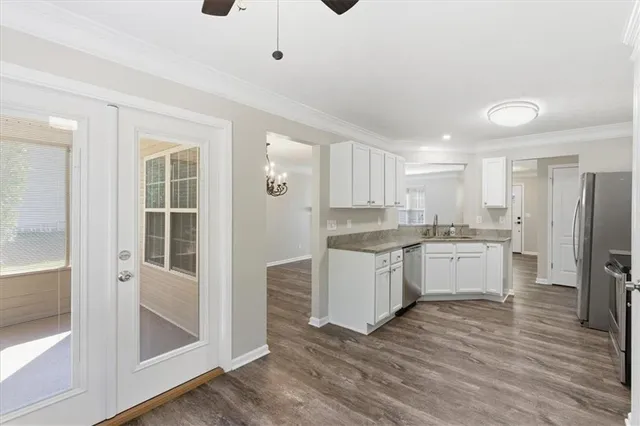a bedroom with a large bed and a flat tv screen on dresser