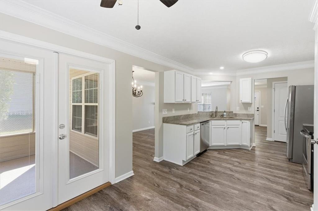 125 Governor Lane Temple, GA 30179 - Photo 19 of 57 a kitchen with a refrigerator and white cabinets