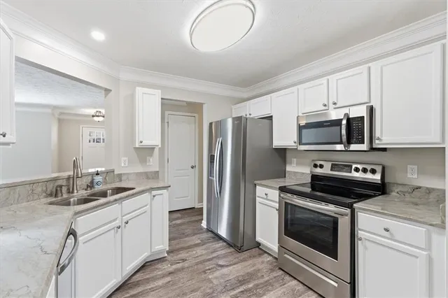 a bathroom with a granite countertop sink a toilet and a mirror