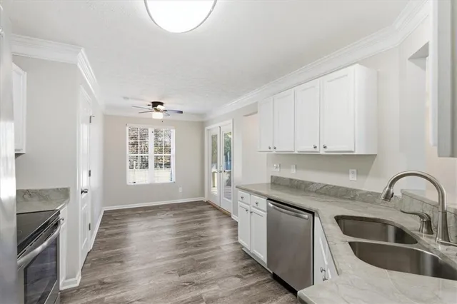 a bedroom with a bed and a ceiling fan