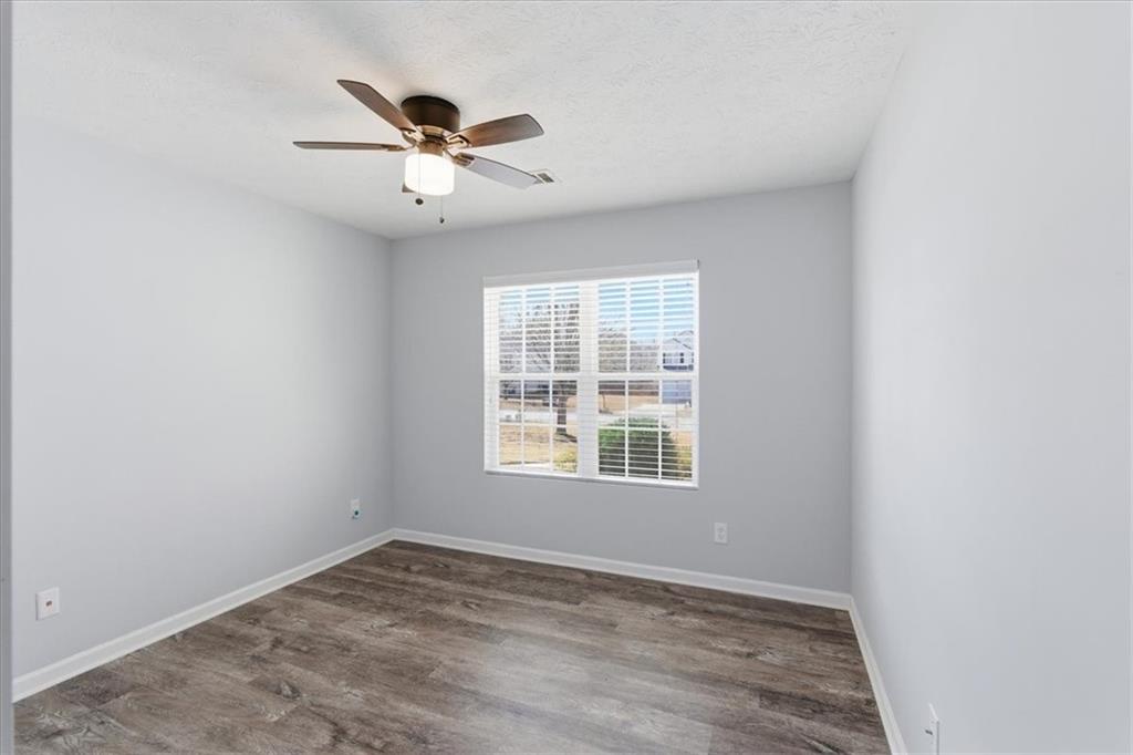 125 Governor Lane Temple, GA 30179 - Photo 36 of 57 an empty room with a window and a ceiling fan
